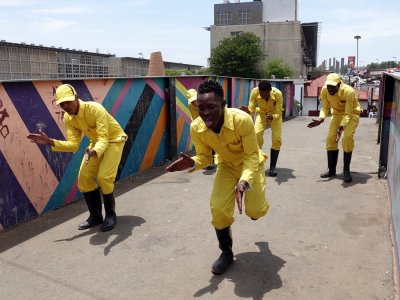 A group of entertainers on the bridge crossing from Walter Sisulu Square to the township that we visited