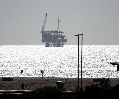 An oil drilling platform a few miles offshore.  Picture taken directly towards the sun at 1/5000 sec.