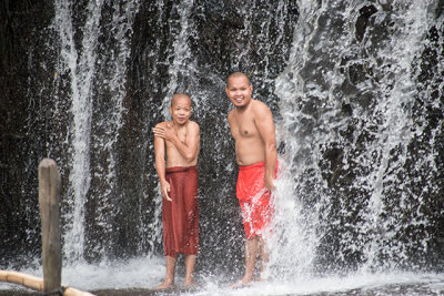 Monks Showering in Mountain Waterfall