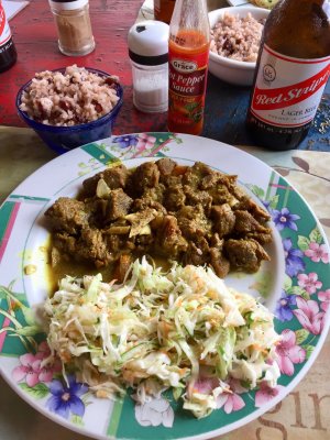 My lunch - Curry Goat, cole slaw, bean & rice, a Red Stripe