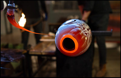 An edge of red glass is put in place around the opening