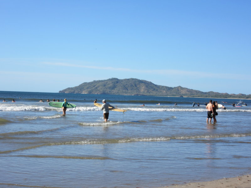 Surfers heading into the water