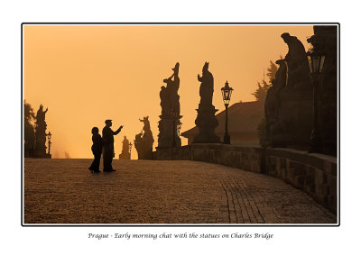  Czech Republic - Prague - Early morning tourists admiring the statues on Charles Bridge 