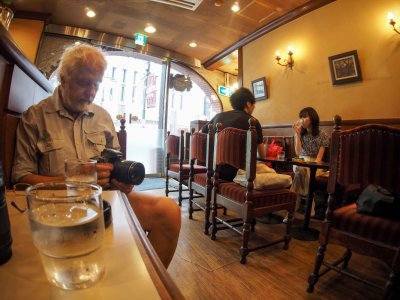 Arnulf checking his pictures in a bar; Tokyo downtown.
