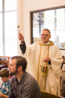 Father Richard sprinkling water