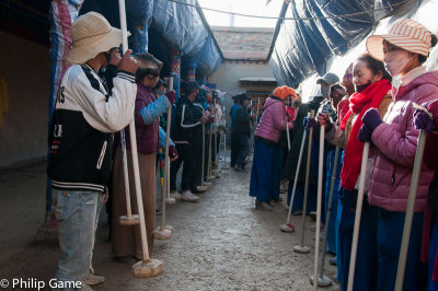It looks like a line dance... actually, these parishioners are tamping down a newly-laid temple floor in Tsetang