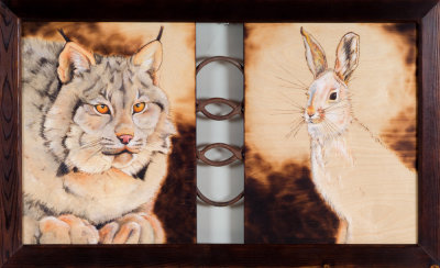 Wood panels with pyrography and metal insert in middle.