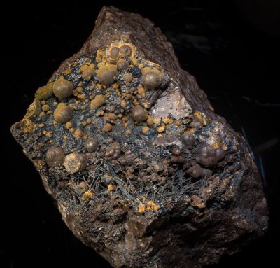 Dufrnite, crystalline spheroids to 7 mm on 8 cm goethite matrix. Wheal Phoenix, Linkinhorne, Cornwall.
