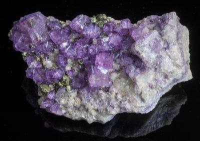 Gemmy purple fluorite crystals to 15 mm with chalcopyrite, 9 cm. St Agnes. Crystals show cube and tetrahexahedron faces.