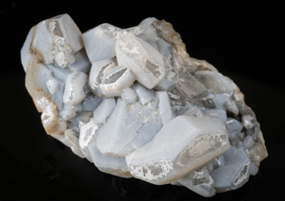 Calcite crystals to 33 mm on 9 cm matrix. Blue-grey calcite overgrowths on colourless cores. Tynebottom Mine, Garrigill.