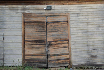 Old barn door with the lamp still there