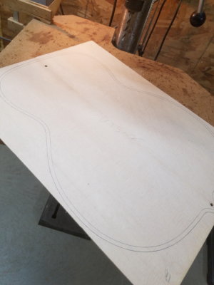 Spruce top glued, sanded to thickness and top traced with location holes for later set-ups.