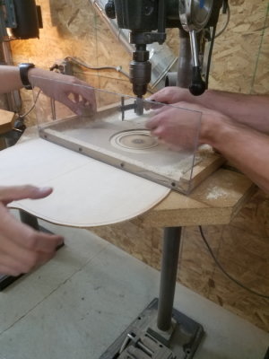 Cutting the sound hole from the top.