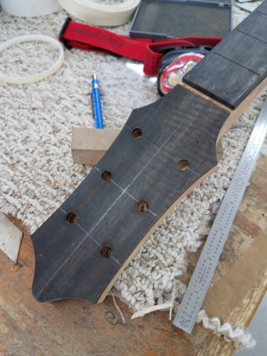 Headstock drilled for tuning machines