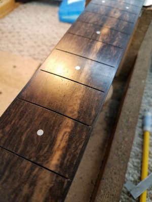 Straight, radiused and polished fretboard