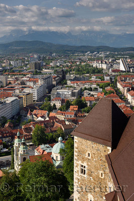 Overview of Saint Nicholas church Ljubljana Cathedral and Kamnik Savinja Alps mountains Slovenia from the hilltop Ljubljana Cast