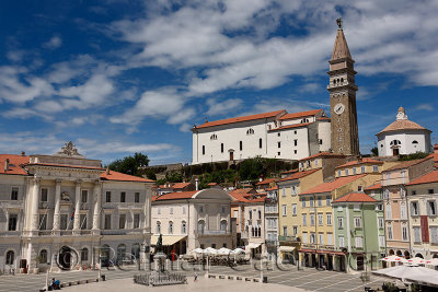Sunny Tartini Square in Piran Slovenia with City Hall, Tartini statue, Venetian House, St. Georges Parish Church with belfry an
