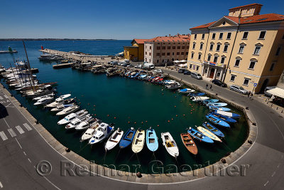 Horseshoe pattern of moored boats at the inner harbour of Piran Slovenia on the Adriatic Sea coast with blue sky