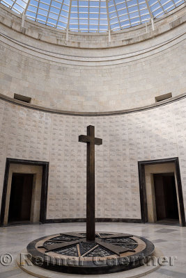 Central cross under skylight with names of the interred at the war memorial for the fallen of World War I at Oslavia Italy