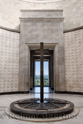 Central cross with names of the interred and view of Italian countryside through door at the WW1 memorial at Oslavia Italy
