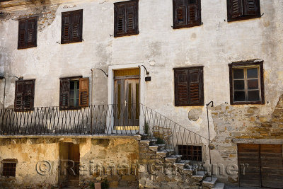 Old stone house with flaking stucco in the small village of Vedrijan Brda Slovenia