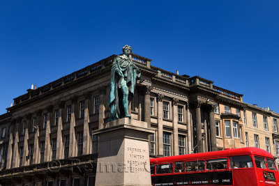 Statue and monument to visit of King George IV to Scotland in 1822 with red bus in George Street Edinburgh Scotland UK