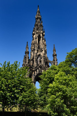 Victorian Gothic architecture of Scott Monument in Princes Street Gardens Edinburgh Scotland UK with blue sky