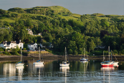 Evening sunlight on sailboats in the harbour of Ardmucknish Bay of Connel Scotland UK near Oban
