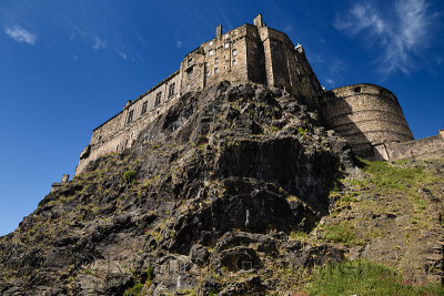 Volcanic plug cliff face of Castle Rock and Great Hall of the Royal Palace and half moon battery of Edinburgh Castle in Edinburg