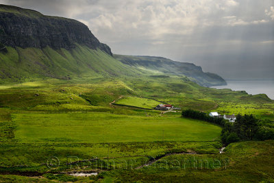 Sun breaking through clouds at Balmeanach Farm and cliffs of Creag a Ghaill with Allt na Teangaidh stream to Loch Na Keal Isle o