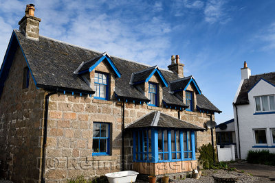 Stone house with blue trim on main street of Baile Mor village on Isle of Iona Inner Hebrides Scotland UK