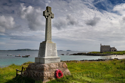 Marble Celtic cross war memorial with wreath on Martyr's Bay Sound of Iona South of Baile Mor village on Isle of Iona Inner Hebr