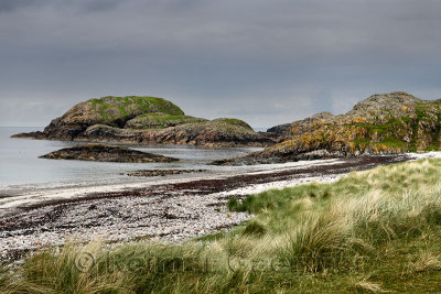 Seaside grass and granite outcropping on the shore of The Bay at the Back of the Ocean at The Machair on Isle of Iona Inner Hebr