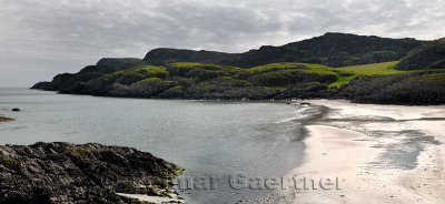Panorama of sea cliffs and pasturland at Sandeels Bay above sandy beach on Isle of Iona Inner Hebrides Scotland UK