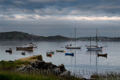 Baile Mor village harbour at dusk with moored boats and sailboats on the Sound of Iona looking from Isle of Iona to Fionnphort I