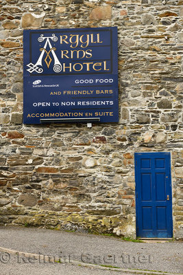 Stone wall of Argyll Arms Hotel with blue sign open to non residents in Bunessan on Isle of Mull Scotland UK