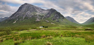 Panorama of white cottage on River Coupall valley with Stob Dhearg peak of Buachaille Etive Mor range at Glen Coe Scottish Highl