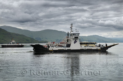 Ardgour to Corran Ferry loaded with cars and bus crossing Loch Linnhe with Highland mountains of Isle of Mull Scotland UK