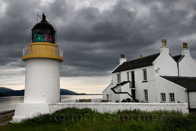 White Corran Lighthouse and Lodge under dark clouds in Ardgour Isle of Mull on the shore of Loch Linnhe Scotland UK