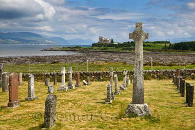 Ancient tombstones and Celtic cross at Kilpatrick Cemetery next to Duart Castle on Isle of Mull on Sound of Mull Loch Linnhe Sco