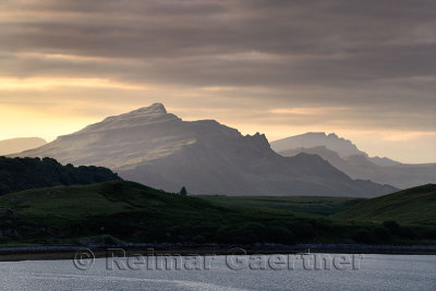 Ben Tianavaig peak at sunset from Sconser on Loch Sligachan with Ben Chracaig and The Storr peaks in distance Isle of Skye Scotl
