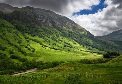 Five Finger Gulley leading up to cloud covered Ben Nevis mountain and green slopes to River Nevis Scottish Highlands Scotland UK