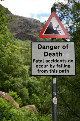 Sign post at Steall Gorge at the foot of Ben Nevis mountain on trail to Steall Waterfall showing danger of death from fatal fall