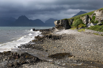 Allt Port na Cullaidh river at Elgol beach with Red Cuillin Mountains under clouds at Loch Scavaig Scottish Highlands Isle of Sk