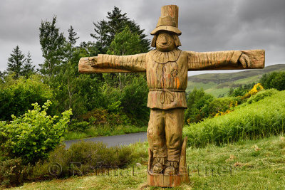 Carved wood Tattie Bogle Scarecrow previously pointing to the Tattie Bogal trail on Carbost Road Drynoch Isle of Skye Scotland