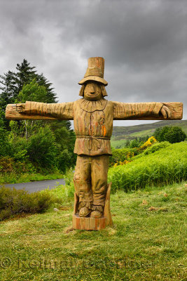Carved wood life size Tattie Bogle Scarecrow previously pointing to the Tattie Bogal trail on Carbost Road Drynoch Isle of Skye 