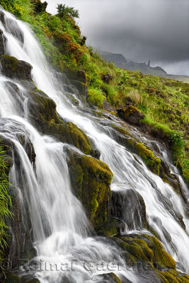 Flowing Bride's Veil WaterFalls to Loch Leathan at The Storr with Old Man of Storr peak in clouds on Isle of Skye Inner Hebrides