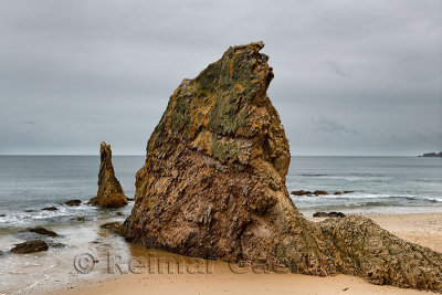 Three Kings red rock quartzite sea stacks on Cullen Bay beach on the North Sea at Cullen Moray Scotland UK