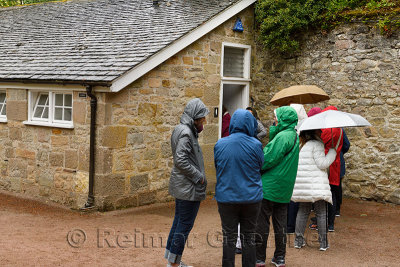 Women lined up for the Ladies room toilet in the rain at Cawdor Castle Nairn Scotland UK