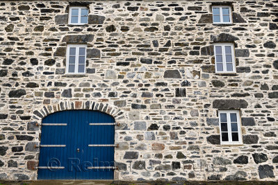 Blue door and windows on stone house at Old Harbourside Portsoy Aberdeenshire Scotland UK